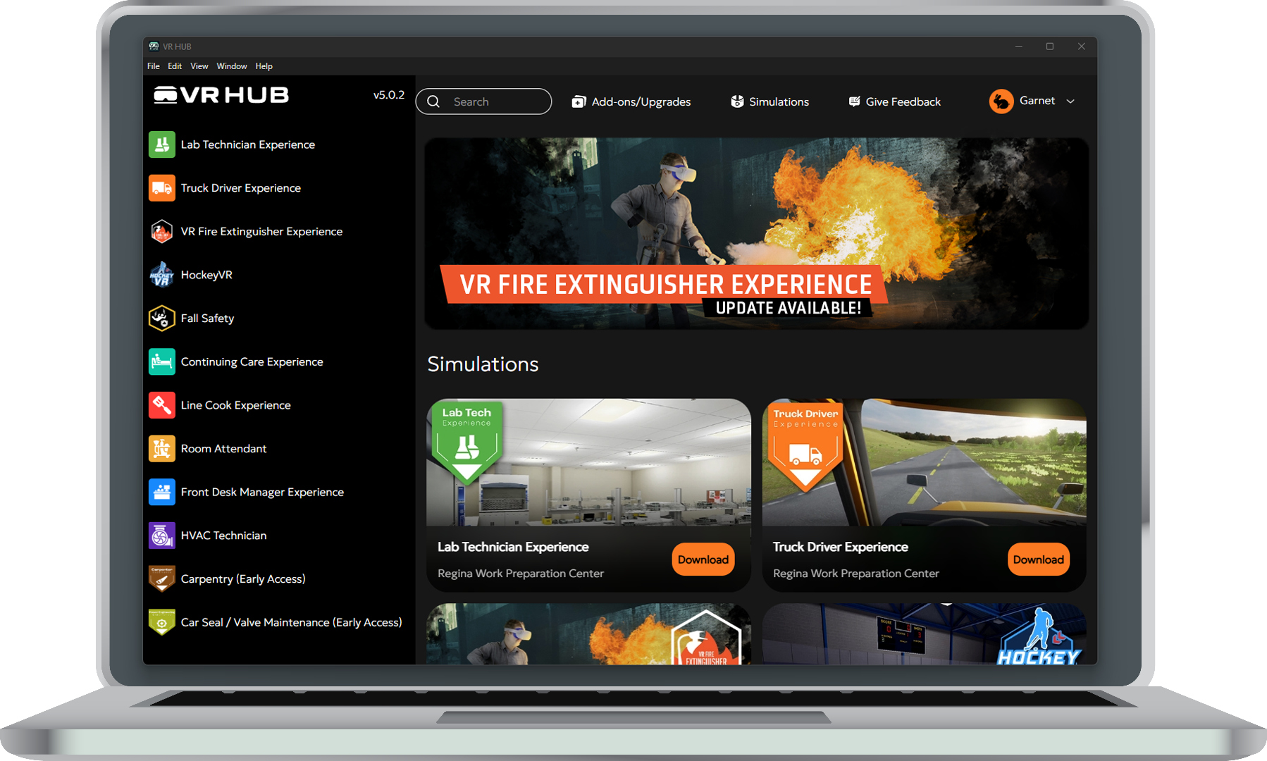 VR Hub application interface showing simulation library on laptop